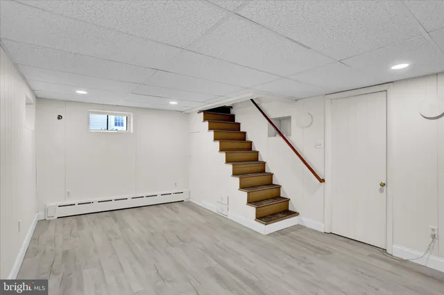 a view of an empty room with stairs and ventilation