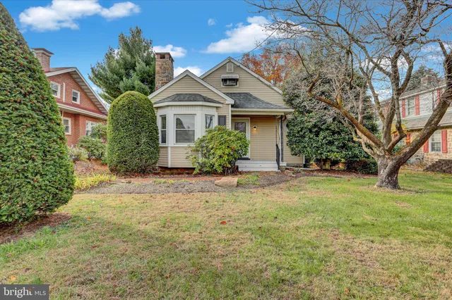 a front view of house with yard and trees
