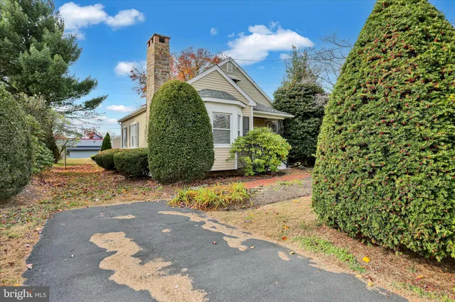 a front view of a house with a yard and fountain