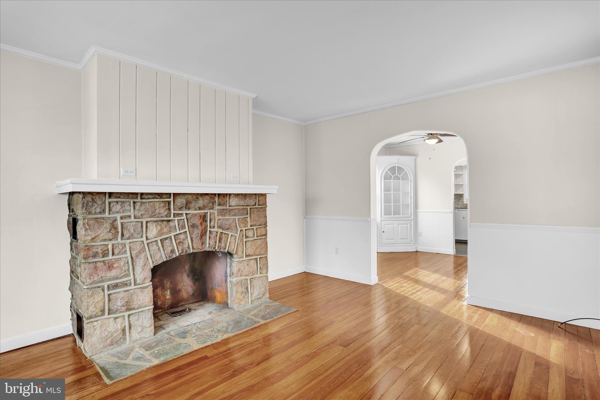 4710 Perkiomen Avenue Reading, PA 19606 - Photo 10 of 39 an empty room with wooden floor and fireplace