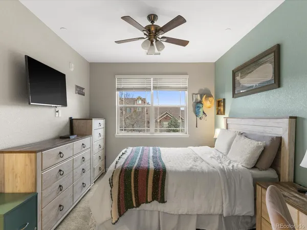 a bathroom with a granite countertop sink a mirror and shower