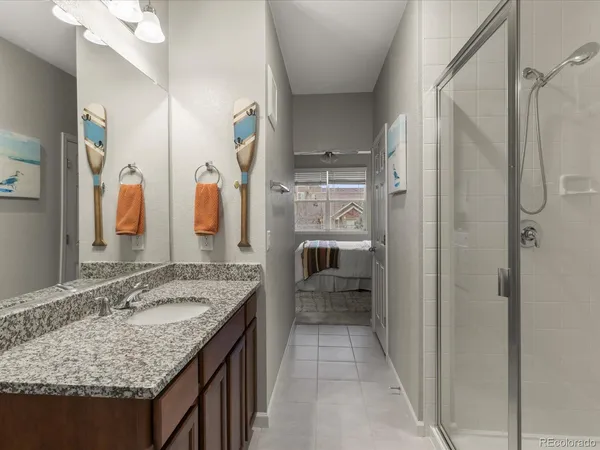 a bathroom with a granite countertop sink and a mirror