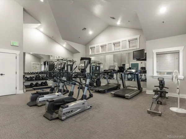 a view of roof deck with a barbeque and wooden floor