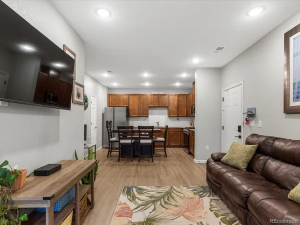 a living room with furniture and kitchen view
