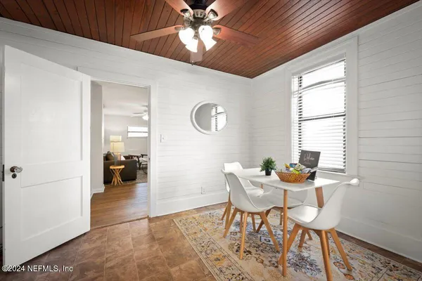 a dining room with furniture and window