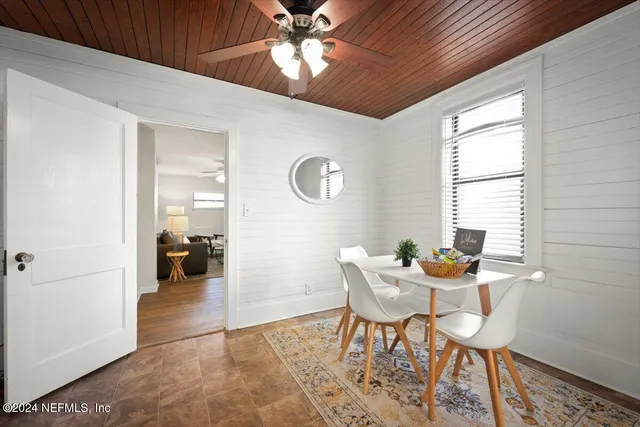 a dining room with furniture and window