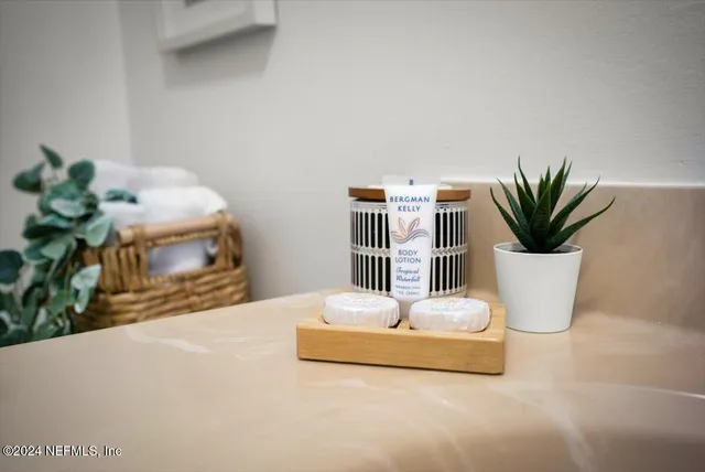 a white vase with white and yellow flowers