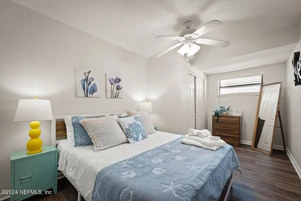 a bedroom with a bed and a chandelier