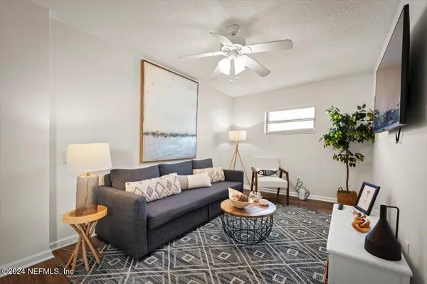 a living room with furniture and a potted plant