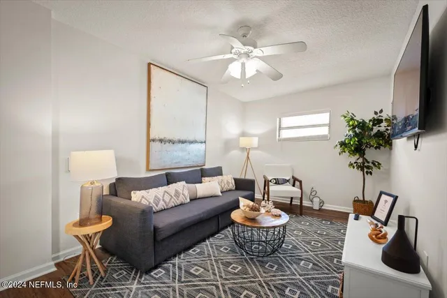 a living room with furniture and a potted plant