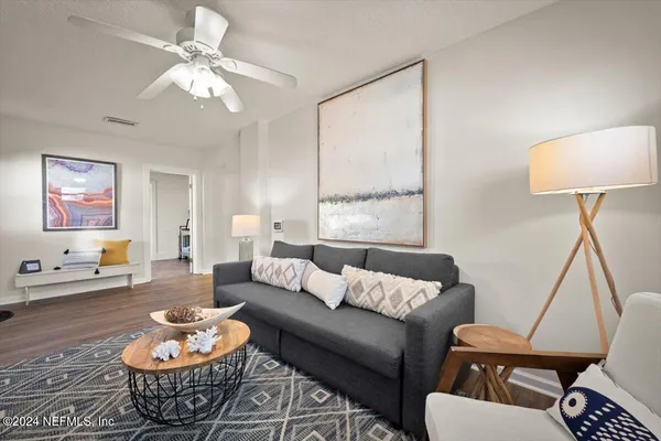 a living room with furniture and a lamp