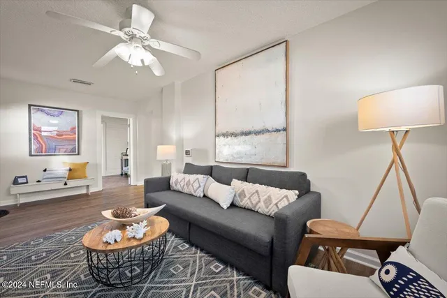 a living room with furniture and a lamp