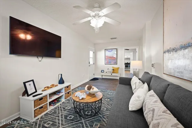 a living room with furniture and a flat screen tv
