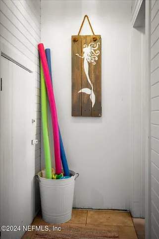 a room with a wooden floor and a potted plant