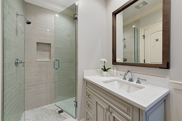 98 Woodley Road Winnetka, IL 60093 - Photo 15 of 21 a bathroom with a sink vanity granite shower and a mirror