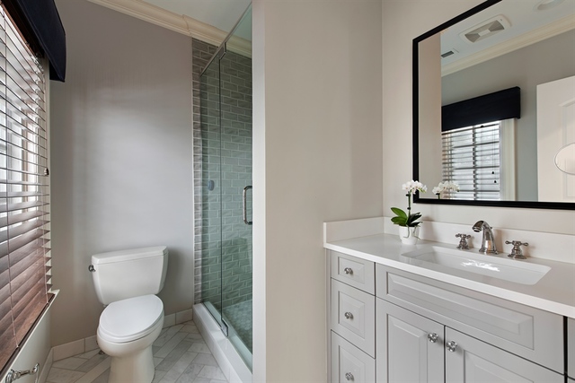 98 Woodley Road Winnetka, IL 60093 - Photo 18 of 21 a bathroom with a granite countertop toilet sink and mirror