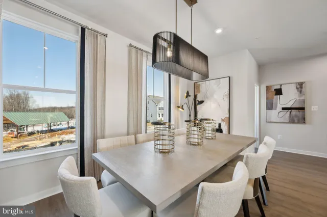 a view of a dining room with furniture wooden floor and chandelier