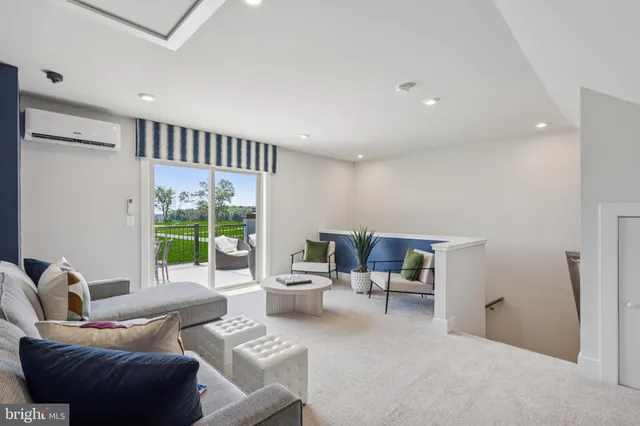 a living room with furniture and a floor to ceiling window