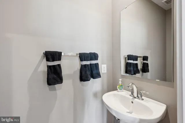 a bathroom with a double vanity sink and mirror