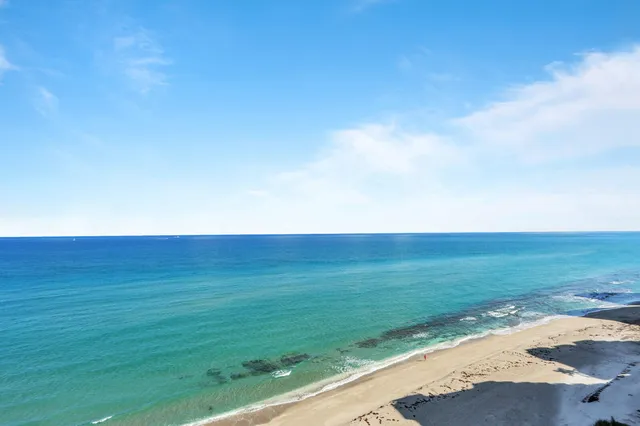a living room with furniture large window and flat screen tv