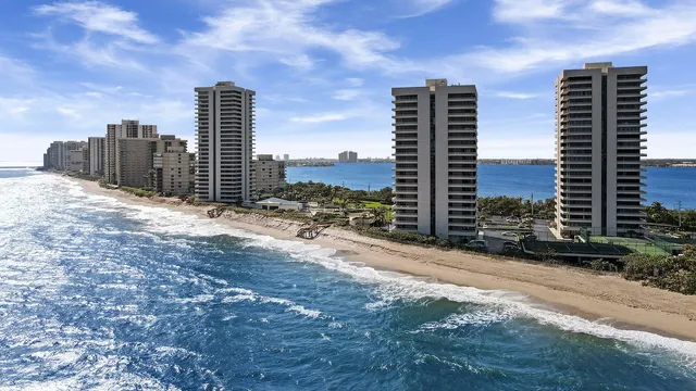 a view of a tennis ground with a large building