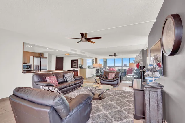 a living room with furniture city view and large windows
