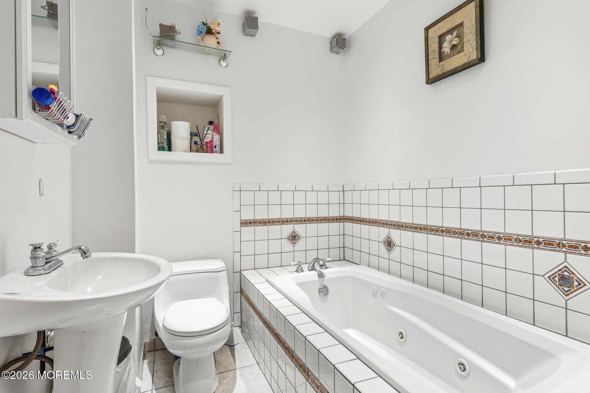1914 Rutherford Avenue Neptune Township, NJ 07753 - Photo 10 of 25 a bathroom with a sink and a mirror