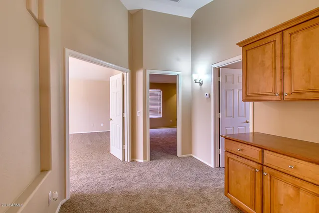 a view of hallway with cabinets