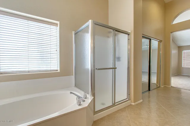a bathroom with a bathtub and a shower