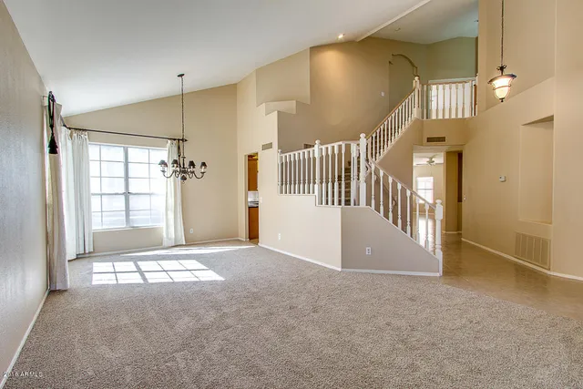 an empty room with windows and entryway