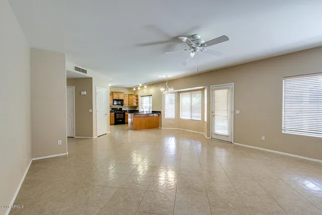 a view of an empty room with window and cabinet