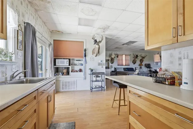 a kitchen with stainless steel appliances a sink counter top space and cabinets