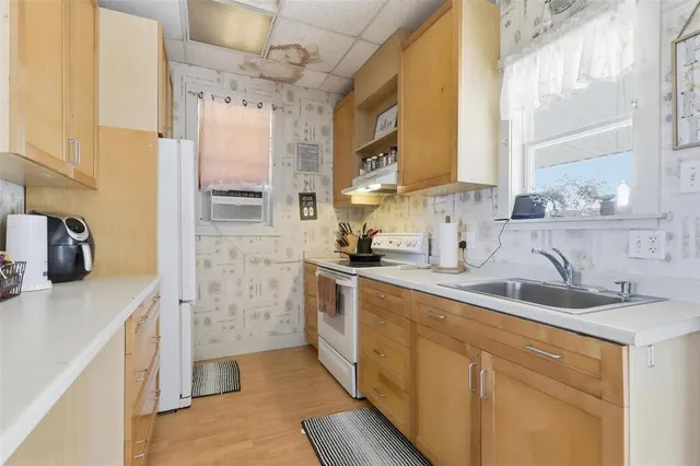a kitchen with cabinets a sink and appliances