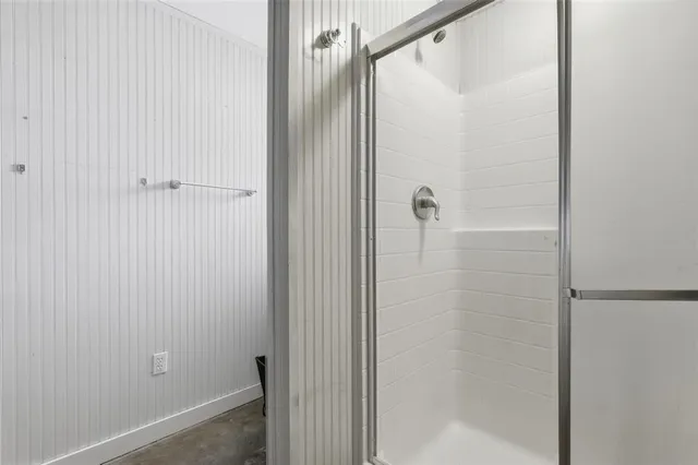 a bathroom with a glass shower door