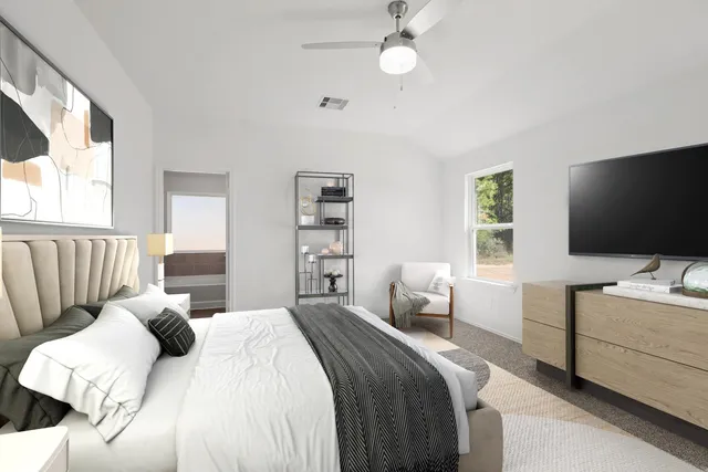 a bedroom with a bed and a flat screen tv on the dresser