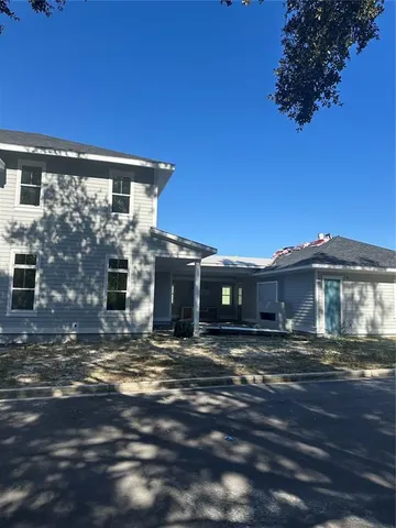 a view of a hallway with wooden floor and cabinet