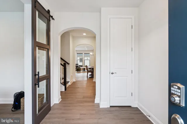 a view of a hallway with wooden floor and staircase