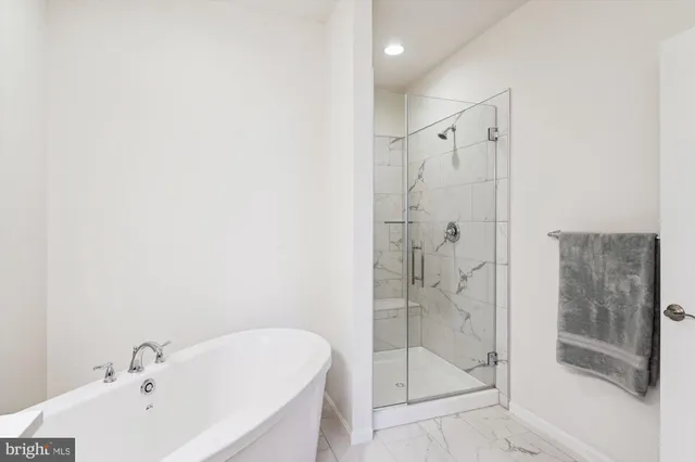 a bathroom with a bathtub and shower