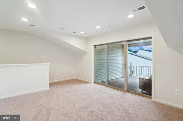 an empty room with a empty space and windows