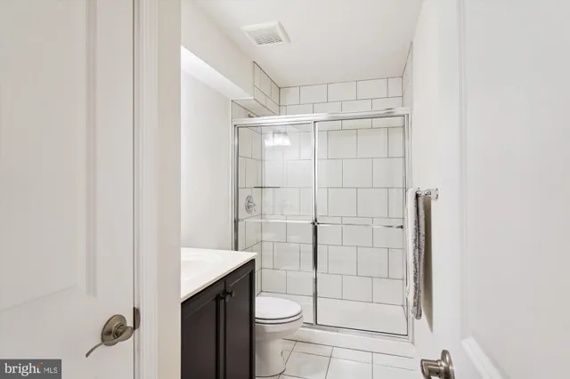 a bathroom with a toilet and a shower