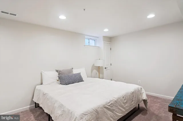 a bedroom with a bed and a night stand