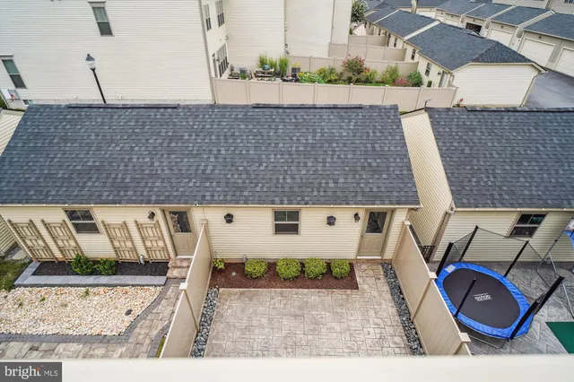 an aerial view of a house with garden space and a couch