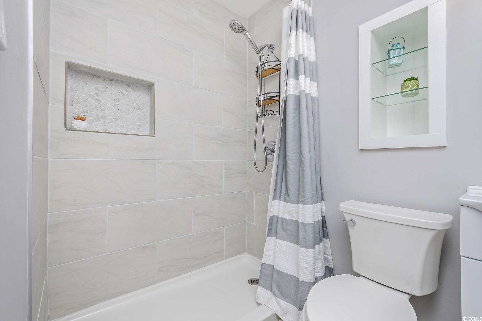 21 Pine Valley Lane Surfside Beach, SC 29575 - Photo 24 of 40 Bathroom featuring a shower with curtain, toilet,