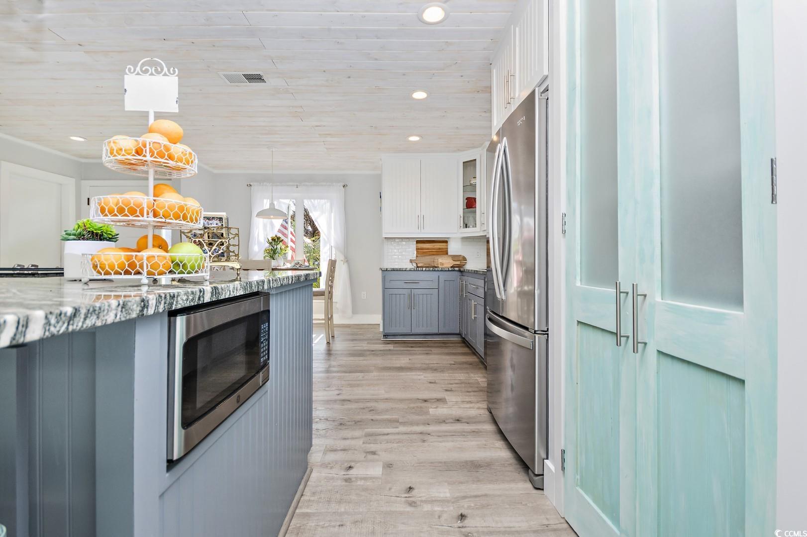 21 Pine Valley Lane Surfside Beach, SC 29575 - Photo 10 of 40 Kitchen with wooden ceiling, backsplash, white cab