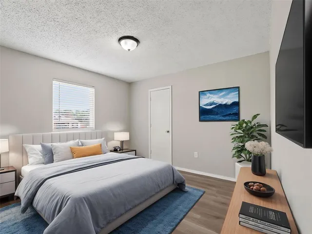 a bedroom with bed and a potted plant