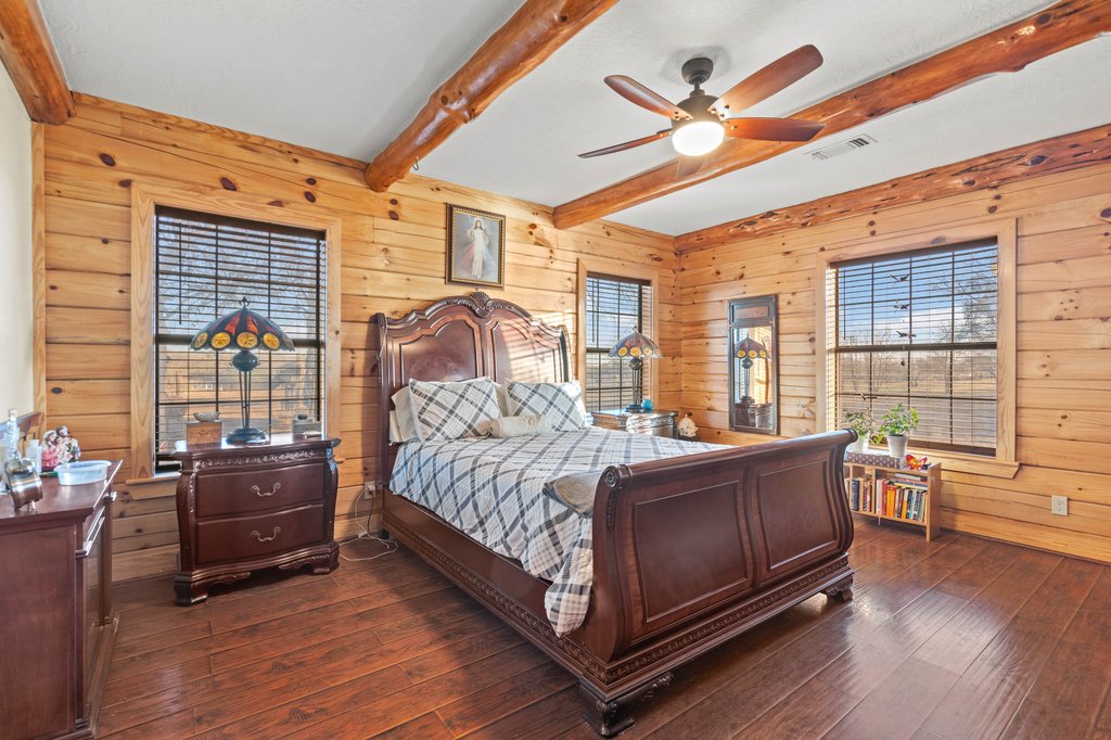 1843 Farm To Market 969 Elgin, TX 78621 - Photo 12 of 28 a bedroom with a bed and wooden floor