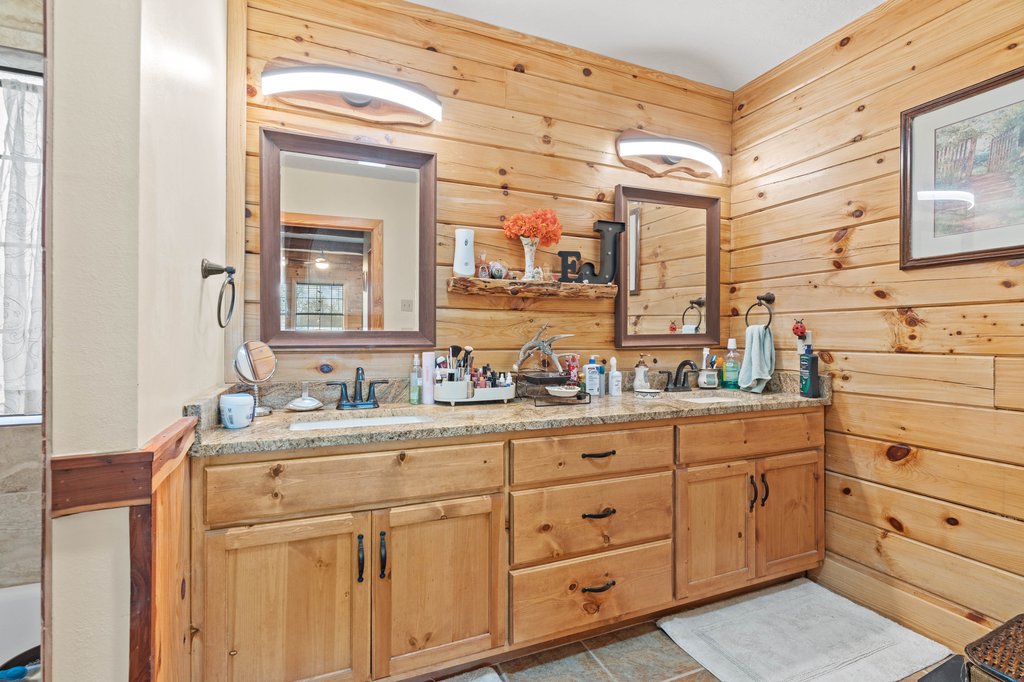 1843 Farm To Market 969 Elgin, TX 78621 - Photo 14 of 28 a bathroom with a granite countertop sink mirror and