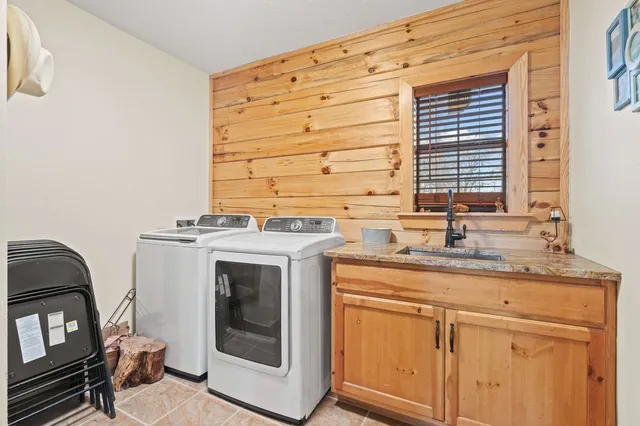 a utility room with faucet washer and dryer