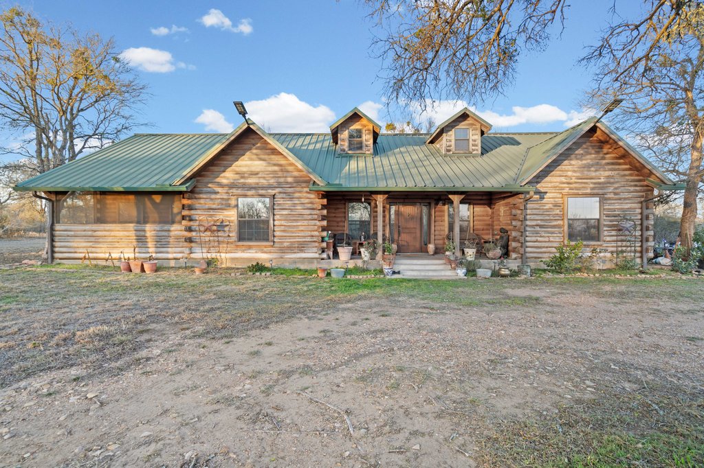 1843 Farm To Market 969 Elgin, TX 78621 - Photo 20 of 28 a front view of a house with garden