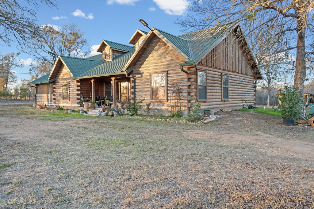 1843 Farm To Market 969 Elgin, TX 78621 - Photo 22 of 28 a front view of a house with garden